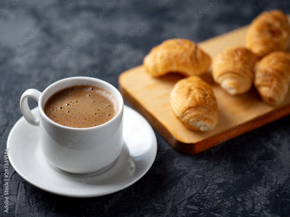 Cup of espresso and a small Breakfast croissants Cup of espresso and a small Breakfast croissants