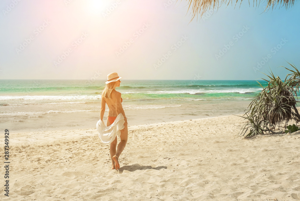Happy traveller woman in white enjoys her tropical beach vacatio Happy traveller woman in white enjoys her tropical beach vacatio