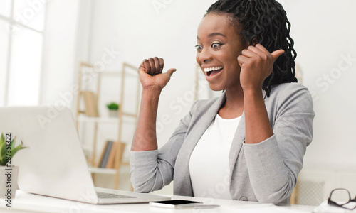 Happy Businesswoman Rejoicing Success Sitting At Laptop Indoor