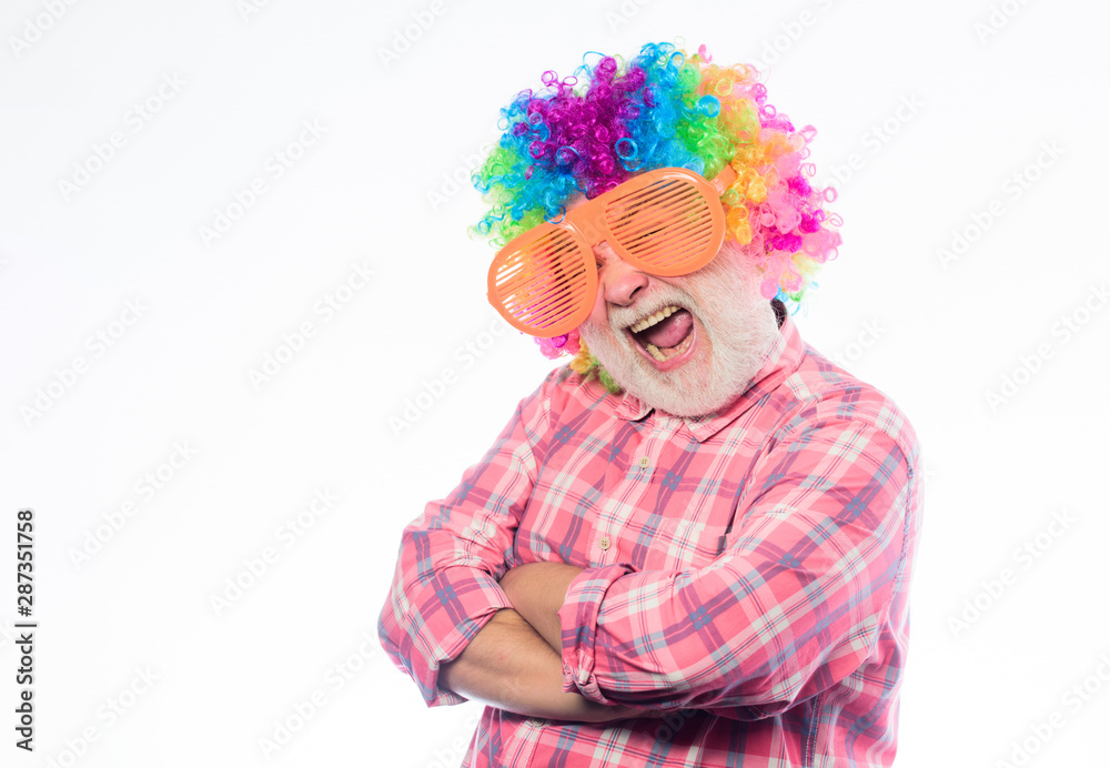 mature bearded man in colorful wig and party glasses. Crazy man in playful mood. happy birthday. corporate party. anniversary holiday. happy man with beard. Celebration retirement. man going crazy