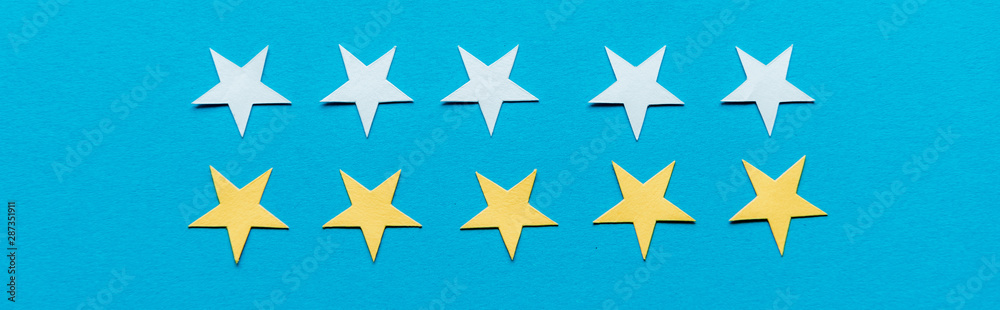 Obraz premium panoramic shot of yellow and white stars isolated on blue
