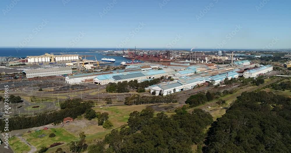 Industrial metal work mills at Port Kembla industrial area near port, steel works, storage, grain elevators, shipment terminal – Australian Pacific coast of NSW. Industrial metal work mills at Port Kembla industrial area near port, steel works, storage, grain elevators, shipment terminal – Australian Pacific coast of NSW.