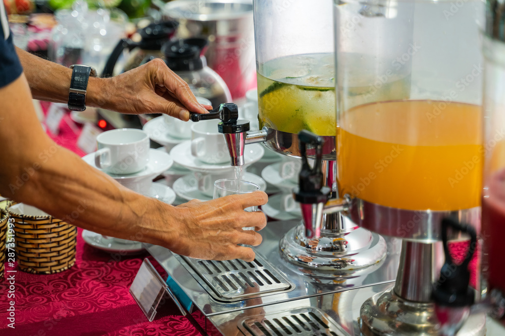 Fresh juice at buffet restaurant, with self service man hand Fresh juice at buffet restaurant, with self service man hand