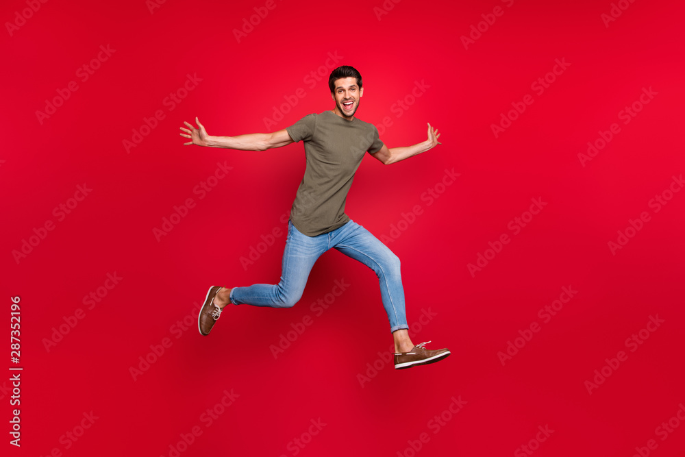 Full size photo of cool guy jumping high glad to see old friend wear casual outfit isolated on red background