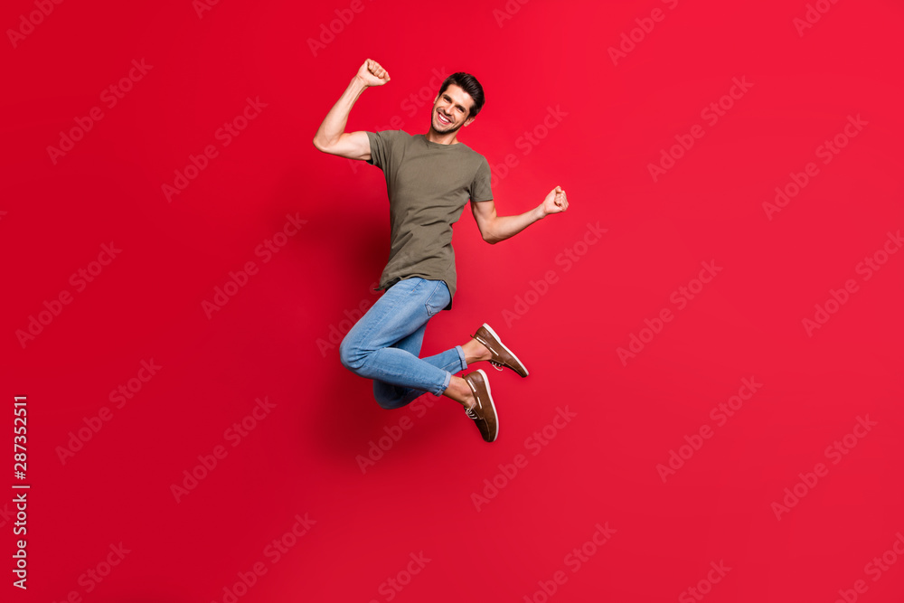 Full body photo of amazing guy jumping high childish mood wear casual outfit isolated on red background