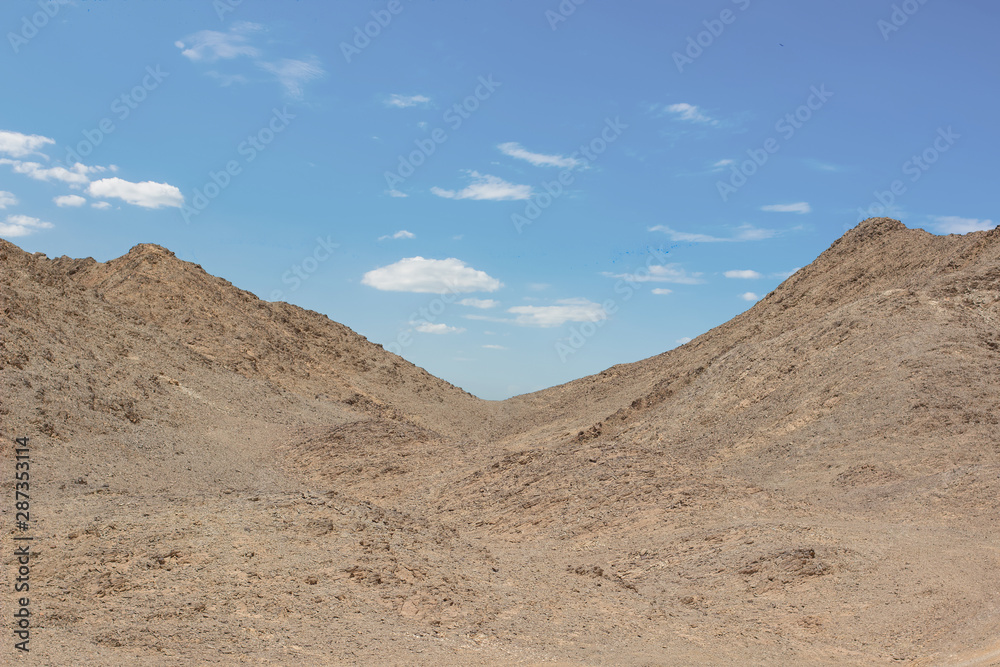 desert rocky hills empty wasteland country side scenery landscape photography in clear weather time and blue sky white clouds background 