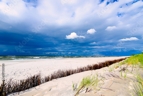 Sandy seaside beach and cloudy sky over the Baltic Sea