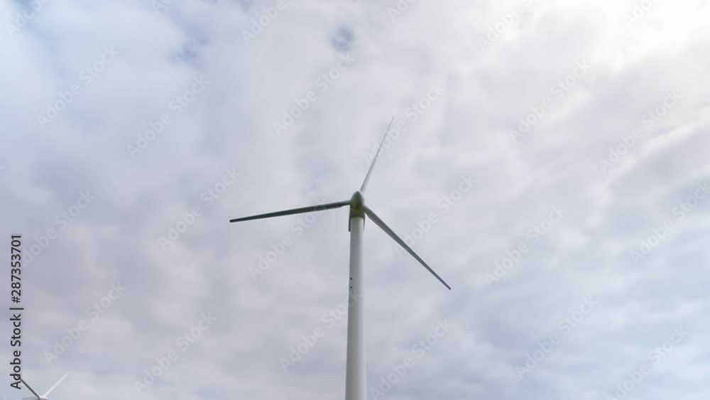 Wind turbines Energy Production on a background of cloudy sky. Full shot. Wind turbines Energy Production on a background of cloudy sky. Full shot.