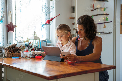 Mother paying with credit card from home photo