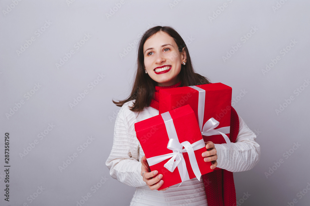 Photo of beautiful woman holding gifts for wonter holidays, free copyspace Photo of beautiful woman holding gifts for wonter holidays, free copyspace