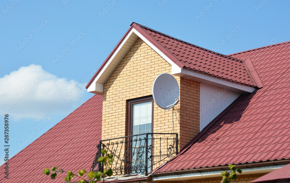 Attic house roofing construction with metal roof and metal balcony