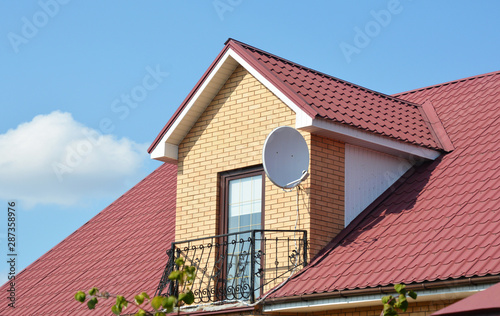 Attic house roofing construction with metal roof and metal balcony