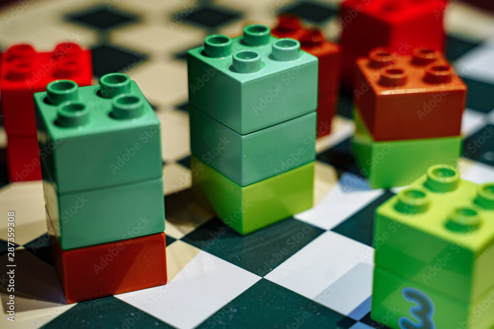 Obraz premium Colorful elements of children's designer on the chessboard