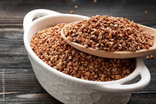 raw buckwheat grains in white bowls