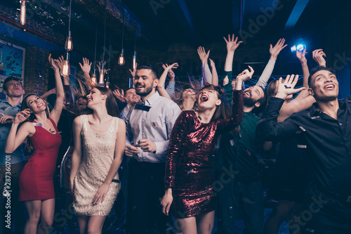 Portrait of charming attractive millennial motion having scream shout rejoice raise hands free time indoors discotheque dress suit formalwear hairstyle
