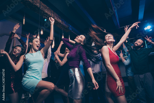 Nice gorgeous adorable attractive glamorous slim fit thin cheerful glad positive stylish girls and guys having fun occasion festal celebratory feast in fashionable luxury place nightclub indoors