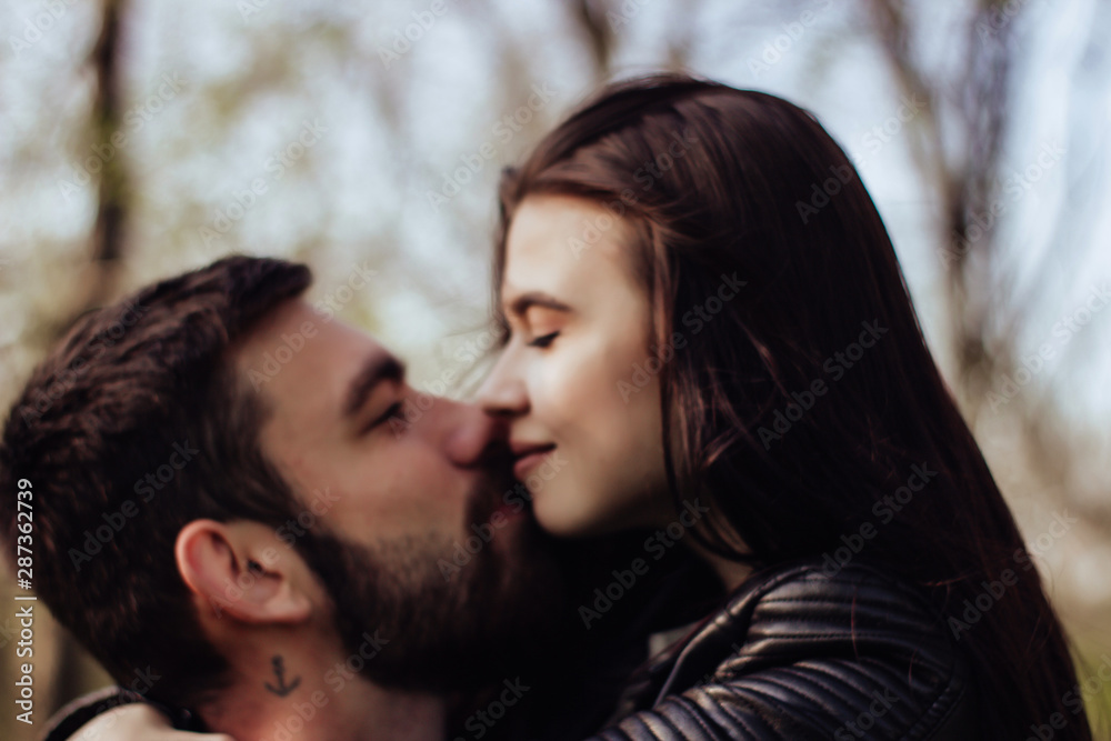 Fototapeta premium Head shot of young affectionate romantic couple in love. Close up portrait of attractive brunette girl and guy with eyes closed, close to each other. Concept of first kiss, tenderness and amorousness