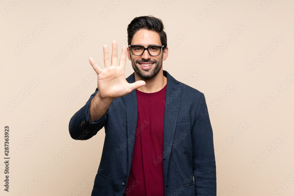Handsome young man over isolated background counting five with fingers Handsome young man over isolated background counting five with fingers
