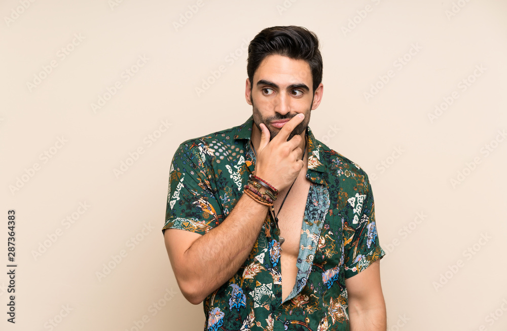 Handsome man in summer shirt over isolated background thinking an idea Handsome man in summer shirt over isolated background thinking an idea