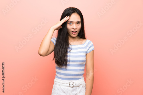 Teenager asian girl over isolated pink background has just realized something and has intending the solution