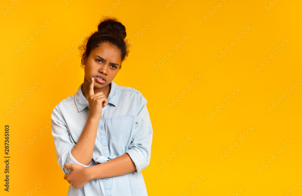 Displeased african girl having doubts about something Displeased african girl having doubts about something
