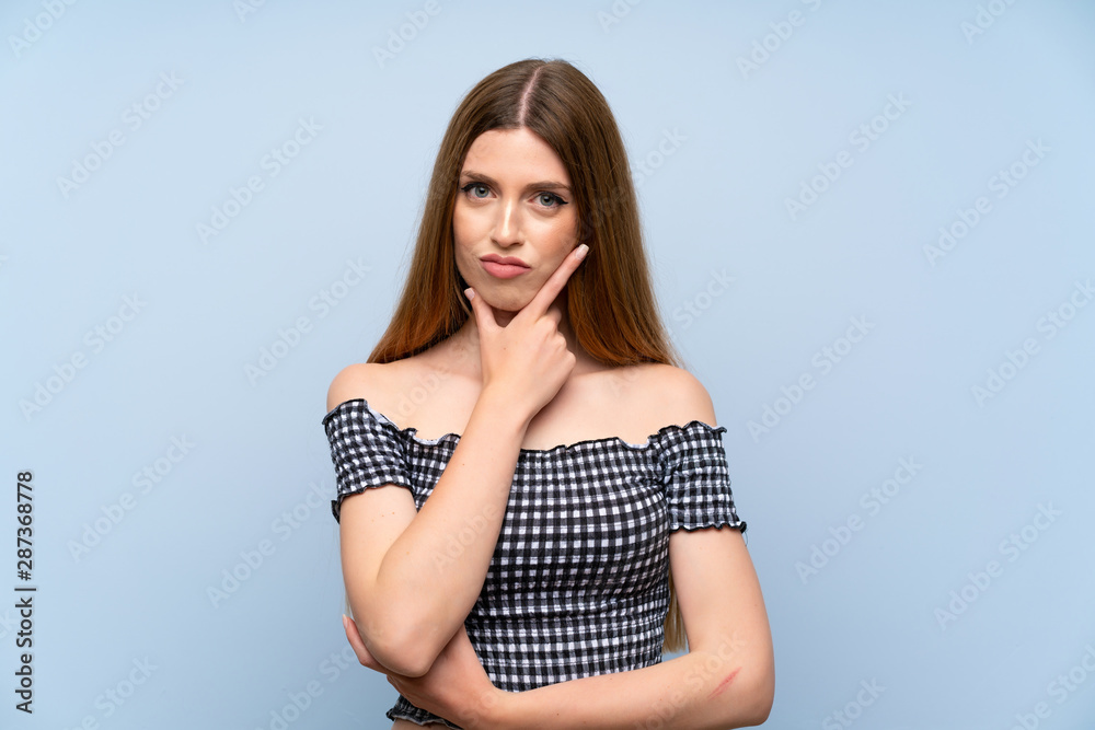 Young woman over isolated blue background thinking an idea Young woman over isolated blue background thinking an idea