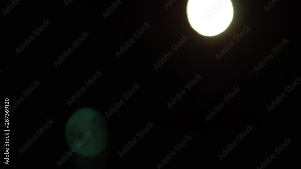 Accelerated video - The moon and its reflection in the black sky Accelerated video - The moon and its reflection in the black sky