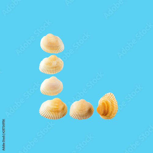 Letter "l" composed from seashells, isolated on gentle blue background
