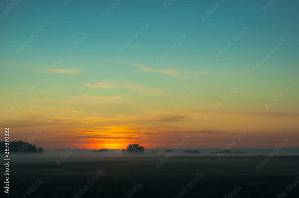 A summer sunrise with tender perl colors and mistic mist 