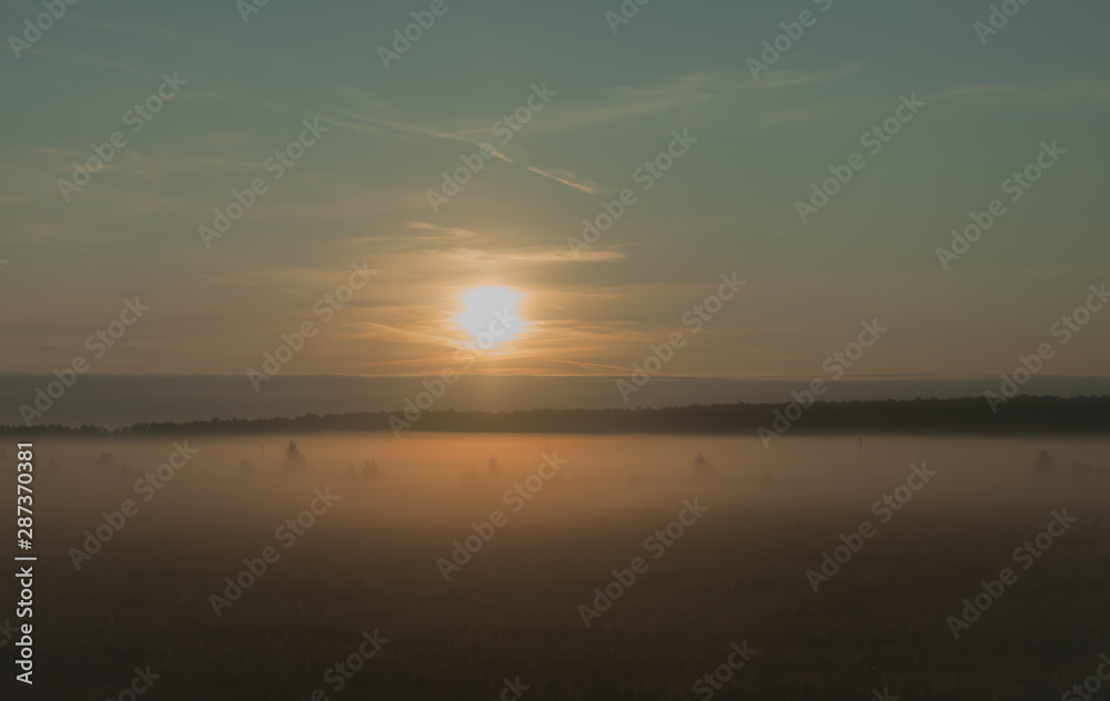 A summer sunrise with tender perl colors and mistic mist 