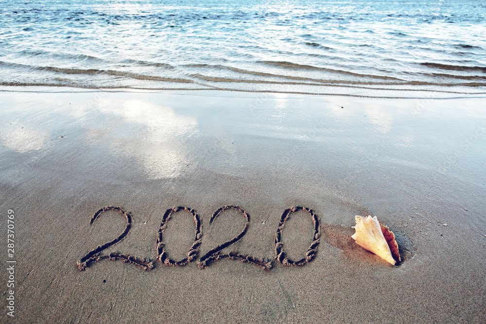 New Year 2020 is coming concept on tropical beach. - obrazy, fototapety, plakaty 