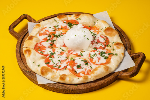 vegetarian pizza with tomato and mozzarella photo