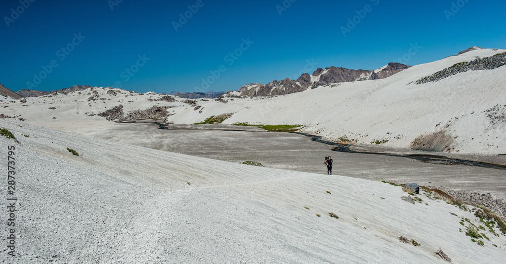 Photography A young woman with backpack in unique white sand desert mountains in Patagonia, Chile