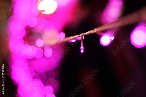 Glamour Ultra Violet sparkling and purple glitter bokeh of metallic circle. Multicolored Christmas and New Year glowing light abstract for Christmas and holiday concept.