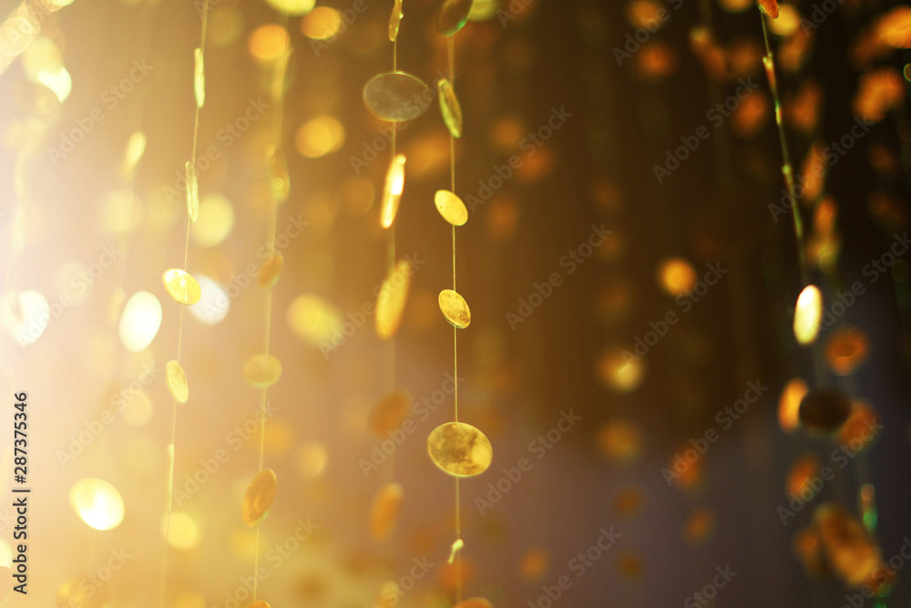 Glamour sparkling and purple glitter bokeh of golden metallic circle. Multicolored Christmas and New Year glowing light abstract for Christmas and holiday concept.