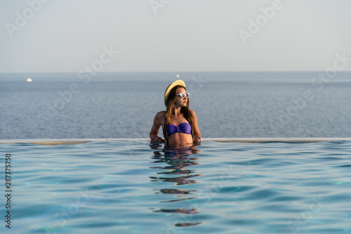 Young woman in hat relaxing at the pool © F8  \ Suport Ukraine