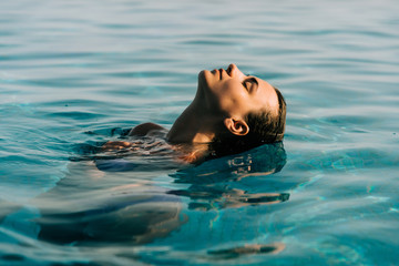 Young woman swim in the swimming pool