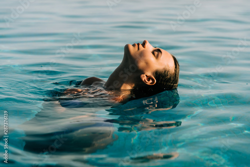 Young woman swim in the swimming pool