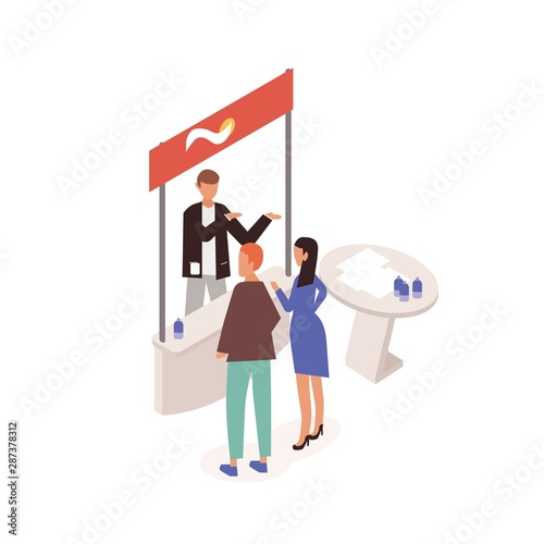 Man and woman standing in front of commercial promo stand and talking to promoter, seller or consultant