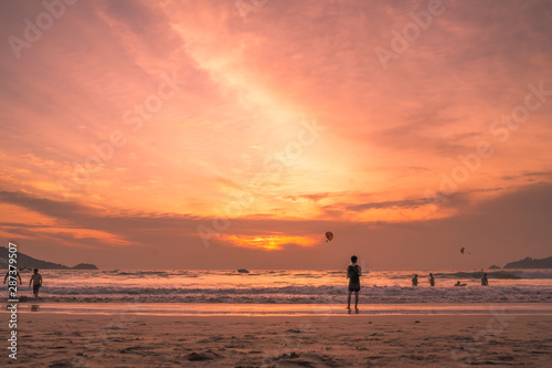 Sunset lovers, bright orange sky, on the beach Famous Phuket Patong Thailand