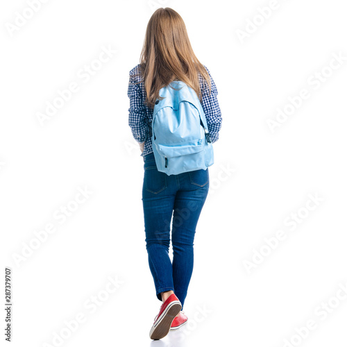Woman in casual clothing student with backpack looking goes walking on white background isolation, back view