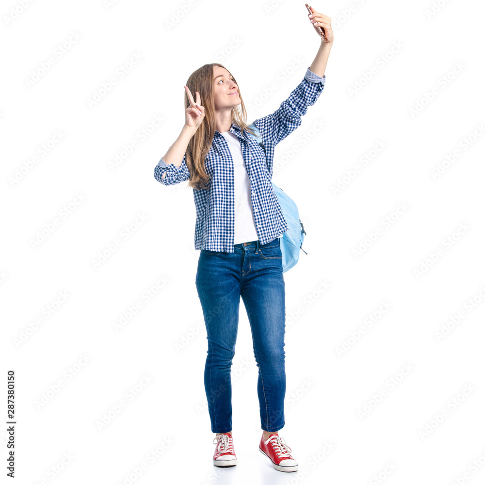 Woman in casual clothing student with backpack standing looking smiling, making selfie smaartphone mobile phone on white background isolation Woman in casual clothing student with backpack standing looking smiling, making selfie smaartphone mobile phone on white background isolation