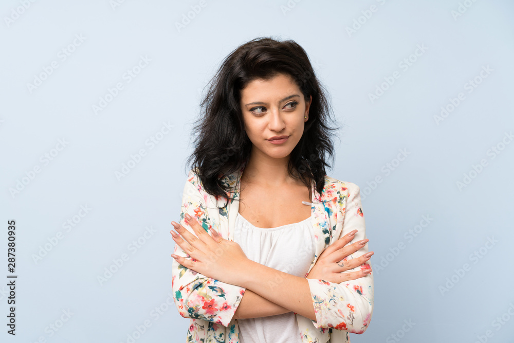 Young woman over isolated blue background thinking an idea Young woman over isolated blue background thinking an idea