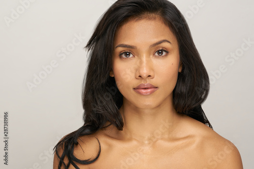 Portrait of young asian woman with black hair in studio