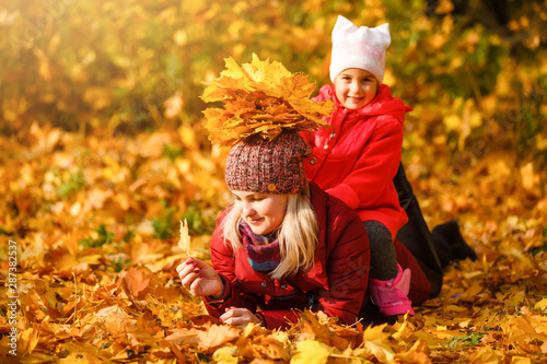 Mother and daughter in a autumn park