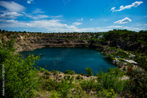 quarry lake among rocks and trees
