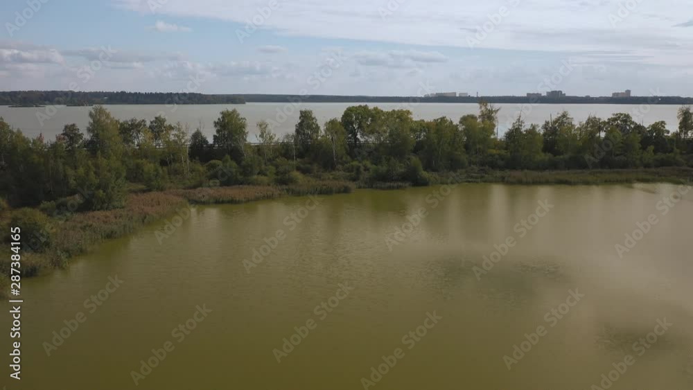 Aerial view of the lake in the middle climatic zone , roads and villages surrounding it Aerial view of the lake in the middle climatic zone , roads and villages surrounding it
