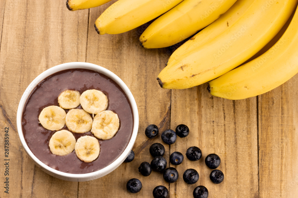 acai bowl beaten with acai and bananas on wooden table top view acai bowl beaten with acai and bananas on wooden table top view