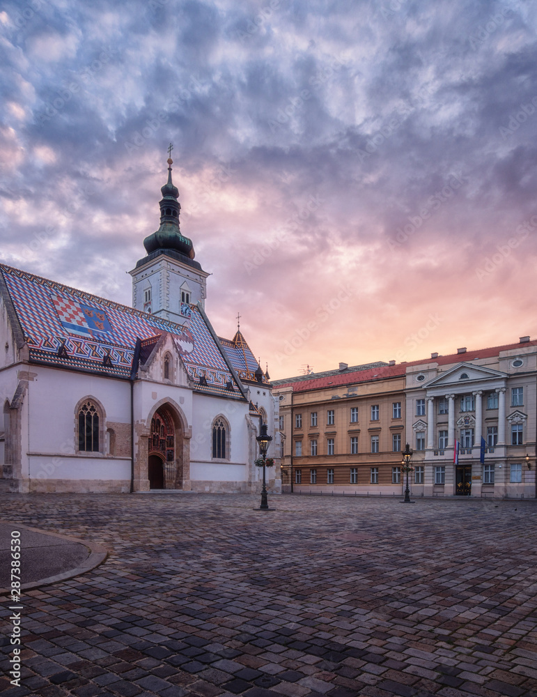 Church of St Mark (Crkva sv Marka) in Zagreb Old city with colourful tiled roof at sunrise. Scenic view of medieval architecture of the historical Upper town (Gradec or Gornij Grad) of Zagreb, Croatia