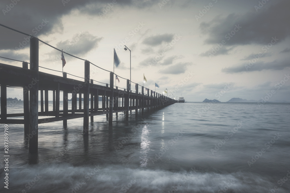 wooden bridge on the sea on a rainy day